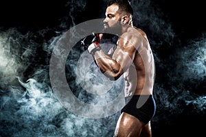Sportsman boxer fighting on black background. Copy Space. Boxing sport concept.