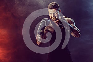 Sportsman boxer fighting on black background with shadow. Copy Space. Boxing sport concept.