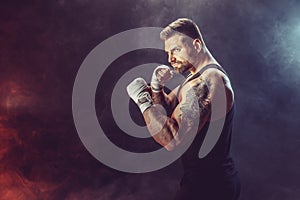 Sportsman boxer fighting on black background with shadow. Copy Space. Boxing sport concept.