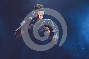 Sportsman boxer fighting on black background with shadow. Copy Space. Boxing sport concept.