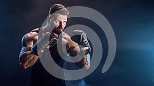 Sportsman boxer fighting on black background with shadow. Copy Space. Boxing sport concept.