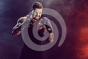 Sportsman boxer fighting on black background with shadow. Copy Space. Boxing sport concept.