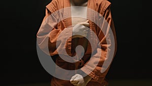 Sportsman boy in a red kimono for judo. Boy puts on a red kimono in preparation for training or sparring