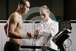 Sportsman with cardiogram electrodes