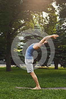 Sportsman doing stretching exercises outdoors
