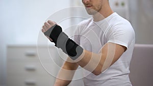 Sportsman fixing titan wrist support, inflammation or sprain, orthopedics