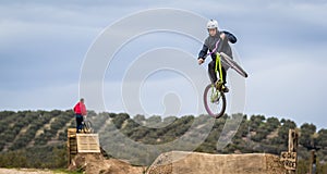 Sportsman flying on bike in dirtjump circuit