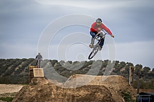 Sportsman flying on bike in dirtjump circuit