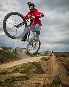 Sportsman flying on a bike in nature