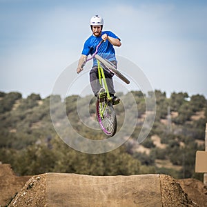 Sportsman flying on a bike in nature