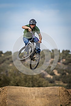 Sportsman flying on a bike in nature