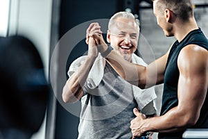 sportsman giving highfive to trainer