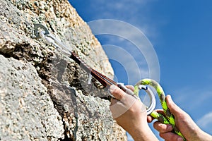 The sportsman hangs up carbine in rock