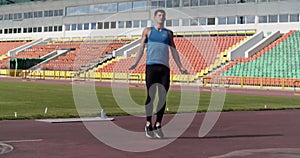Sportsman jumping with rope on stadium