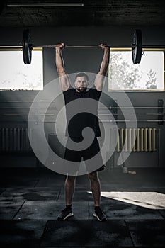 Sportsman Lift Heavy Barbell and Look at Camera .