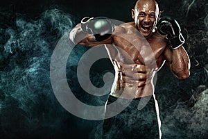 Sportsman, man boxer fighting in gloves on black background. Fitness and boxing concept. Action shoot.