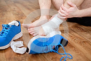 Sportsman massaging his injured ankle