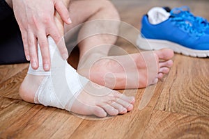 Sportsman massaging his injured ankle