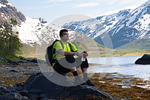 Sportsman on mountains lake