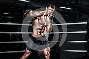 Sportsman muay thai boxer fighting in boxing cage. With copy Space. Sport concept.