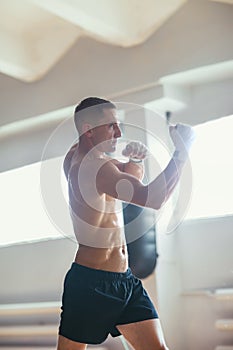 Sportsman muay thai boxer fighting on gym