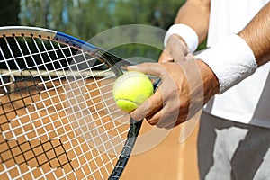Sportsman preparing to serve tennis ball at court