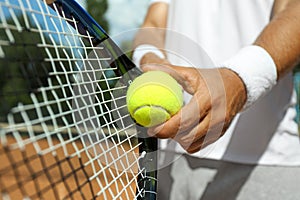 Sportsman preparing to serve tennis ball at court