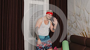 Sportsman retro guy in funny sport clothes waving greeting with hand hello or bye, showing thumbs up