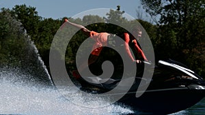 Sportsman riding on speedy jet ski. Extreme rider training stunt on jetski