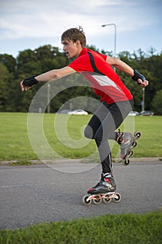 Sportsman on roller skates pose at speed