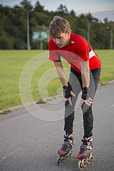 Sportsman on roller is tired and thoughtful