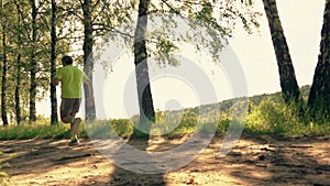 Sportsman running along the park alley