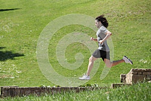 Sportsman running and jumping in a park