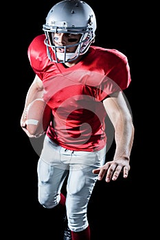 Sportsman running while playing American football