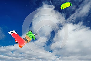 The sportsman on a snowboard runs kite