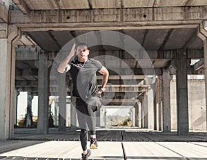 A sportsman on the sprint training at the unfinished,rustic ambient.