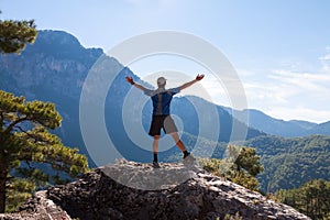 Sportsman on the top of rock. Sport and active