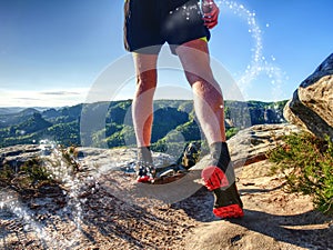 Sportsman on trail. Slim body man in yellow jersey, black shorts