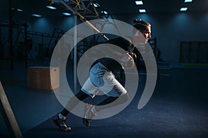 Sportsman on training,endurance workout with ropes