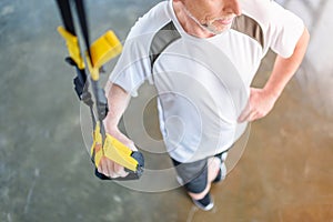 Sportsman training with resistance band in sports center