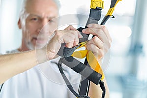 Sportsman training with resistance band in sports center