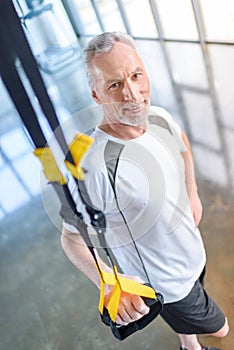 Sportsman training with resistance band in sports center