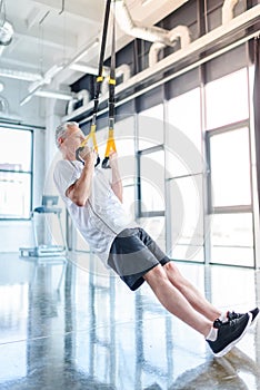 Sportsman training with resistance band in sports center