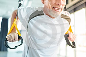 Sportsman training with resistance band in sports center