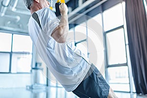 Sportsman training with resistance band in sports center