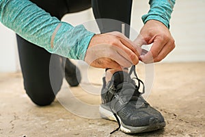 Sportsman tying shoelaces. Young man.