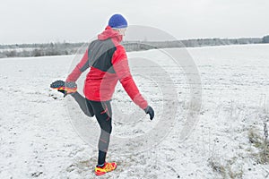 Sportsman during winter training session at snowy field background outdoors