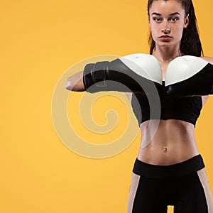 Sportsman, woman boxer fighting in gloves. on yellow background. Boxing and fitness concept.
