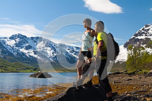 Sportsman and woman near mountain lake