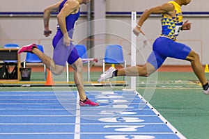 Sportsmen running out finish line in sprint.